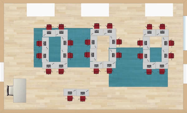 Two desks are positioned front and center for behavior issues or for teacher recognition. The rest of the desks are in team formations.